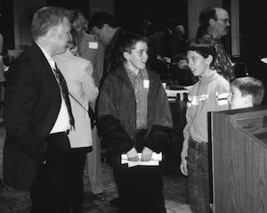 Masters talking with children following a talk.